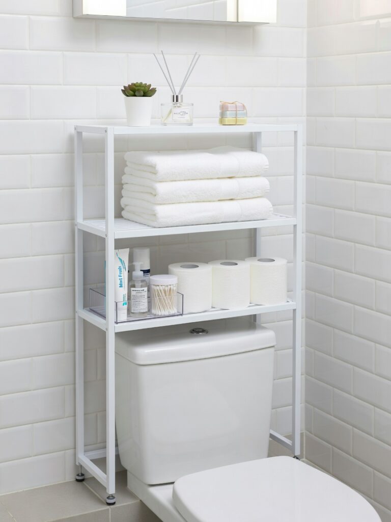 Over-toilet storage rack in rental apartment bathroom for damage-free 
organization and towel storage